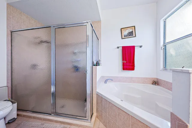 a spacious bedroom with a bed and a chandelier