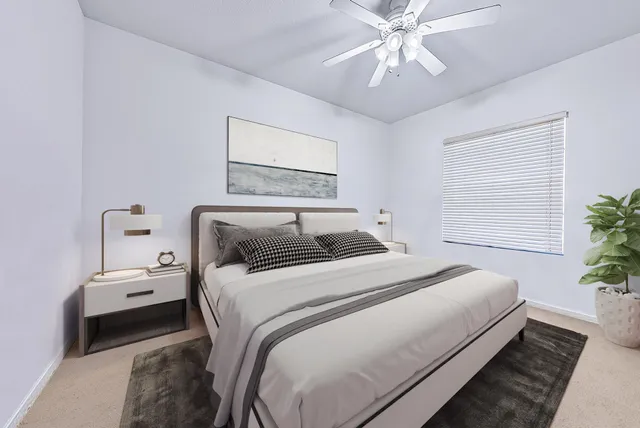 a bathroom with a granite countertop double vanity sink a mirror and a bathtub