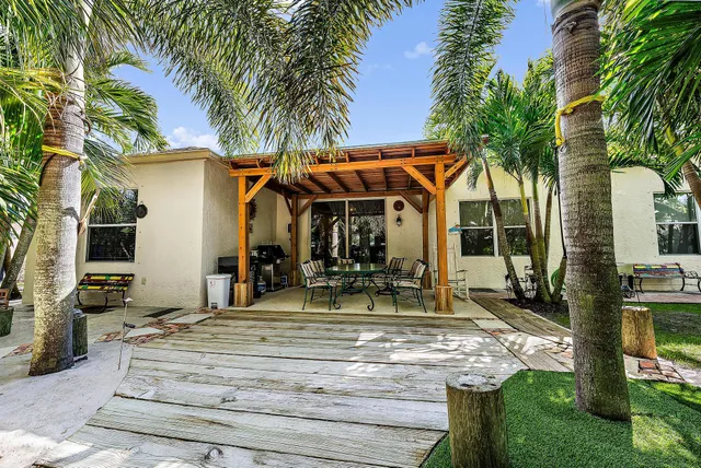 an aerial view of residential houses with outdoor space and swimming pool