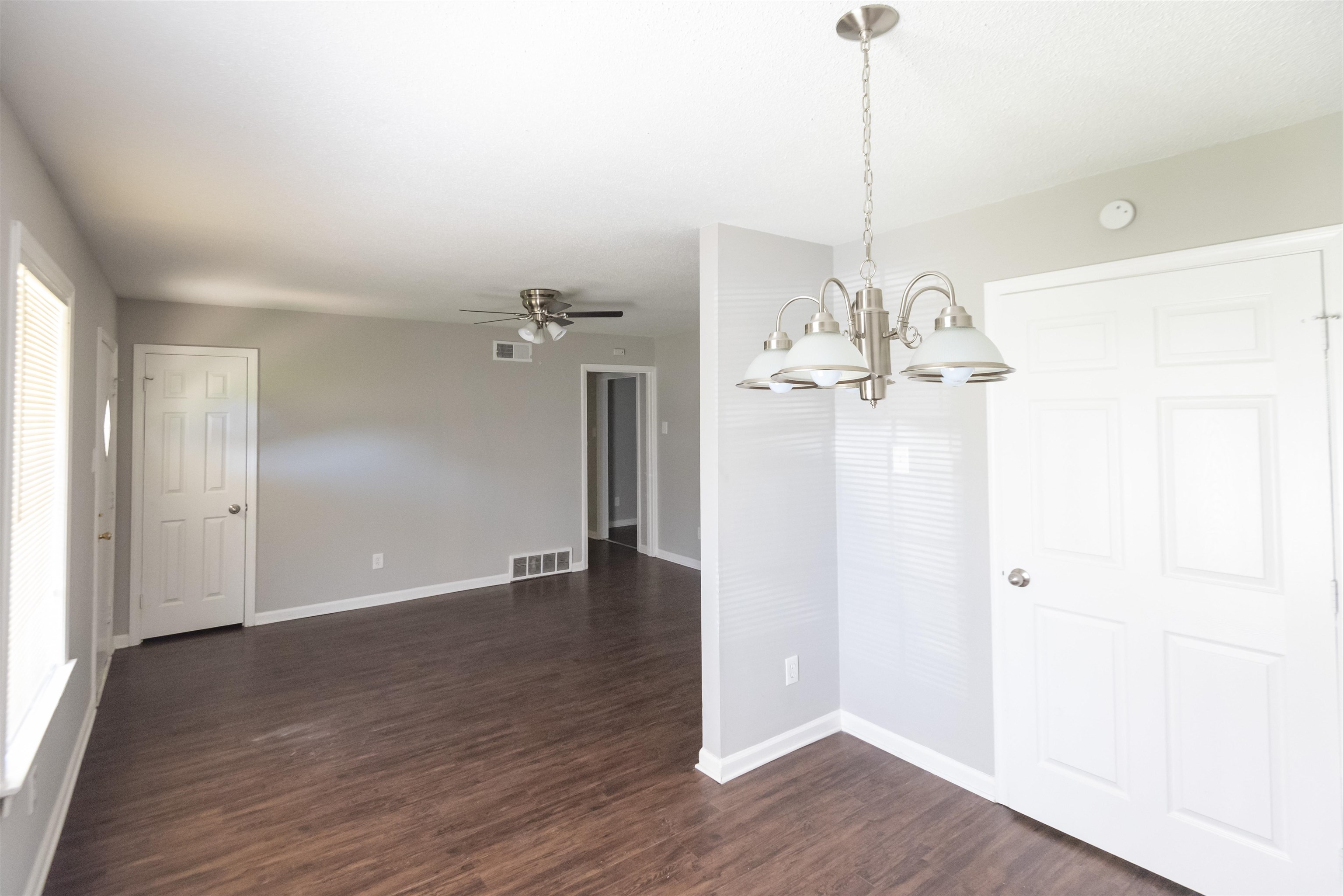 4399 Pepper Tree Road Memphis, TN 38109 - Photo 6 of 14 Wood-finish flooring, neutral wall tones, white trim, and a ceiling fan