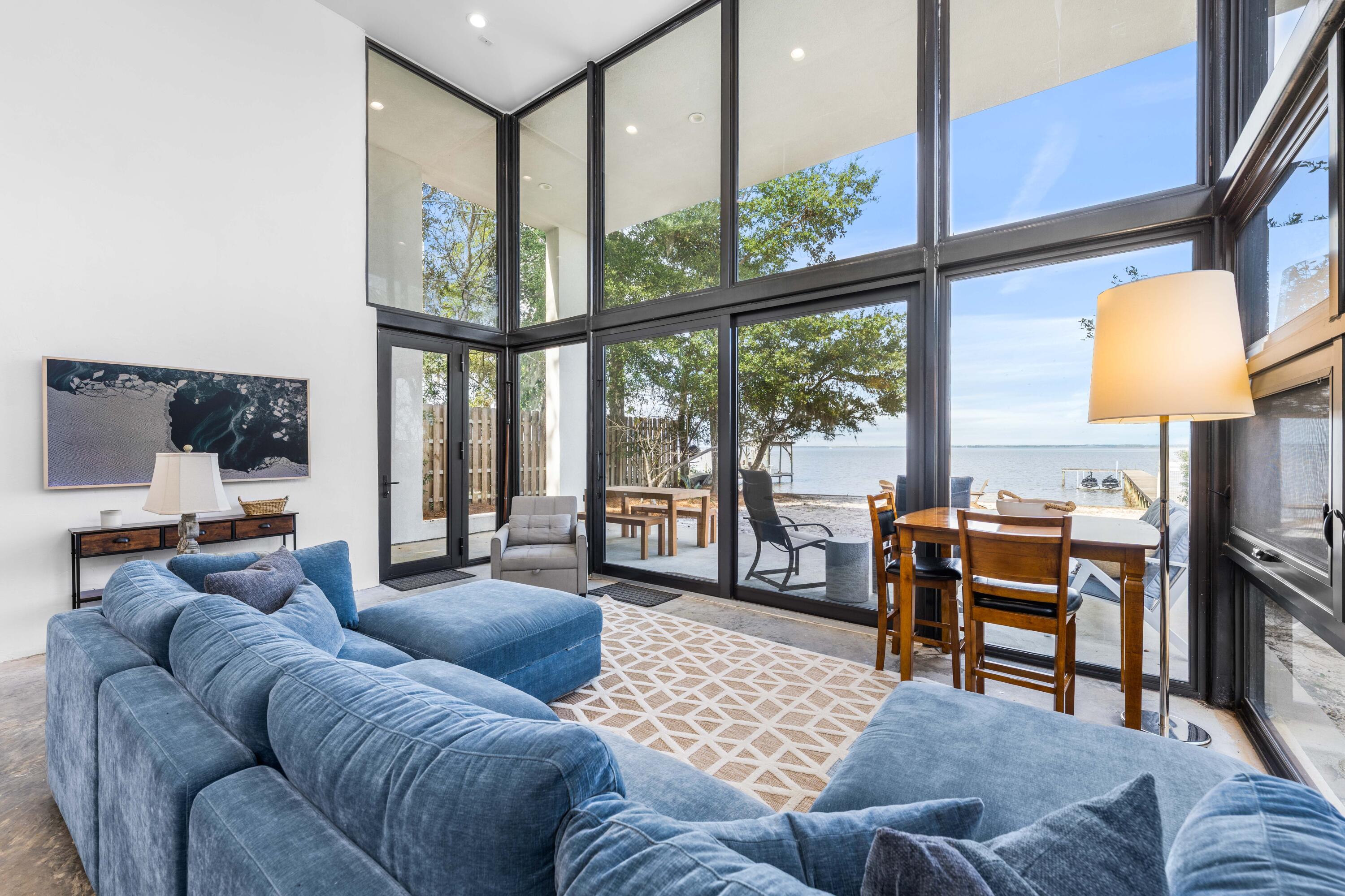 149 Native Tree Lane Santa Rosa Beach, FL 32459 - Photo 11 of 52 a living room with furniture and a floor to ceiling window