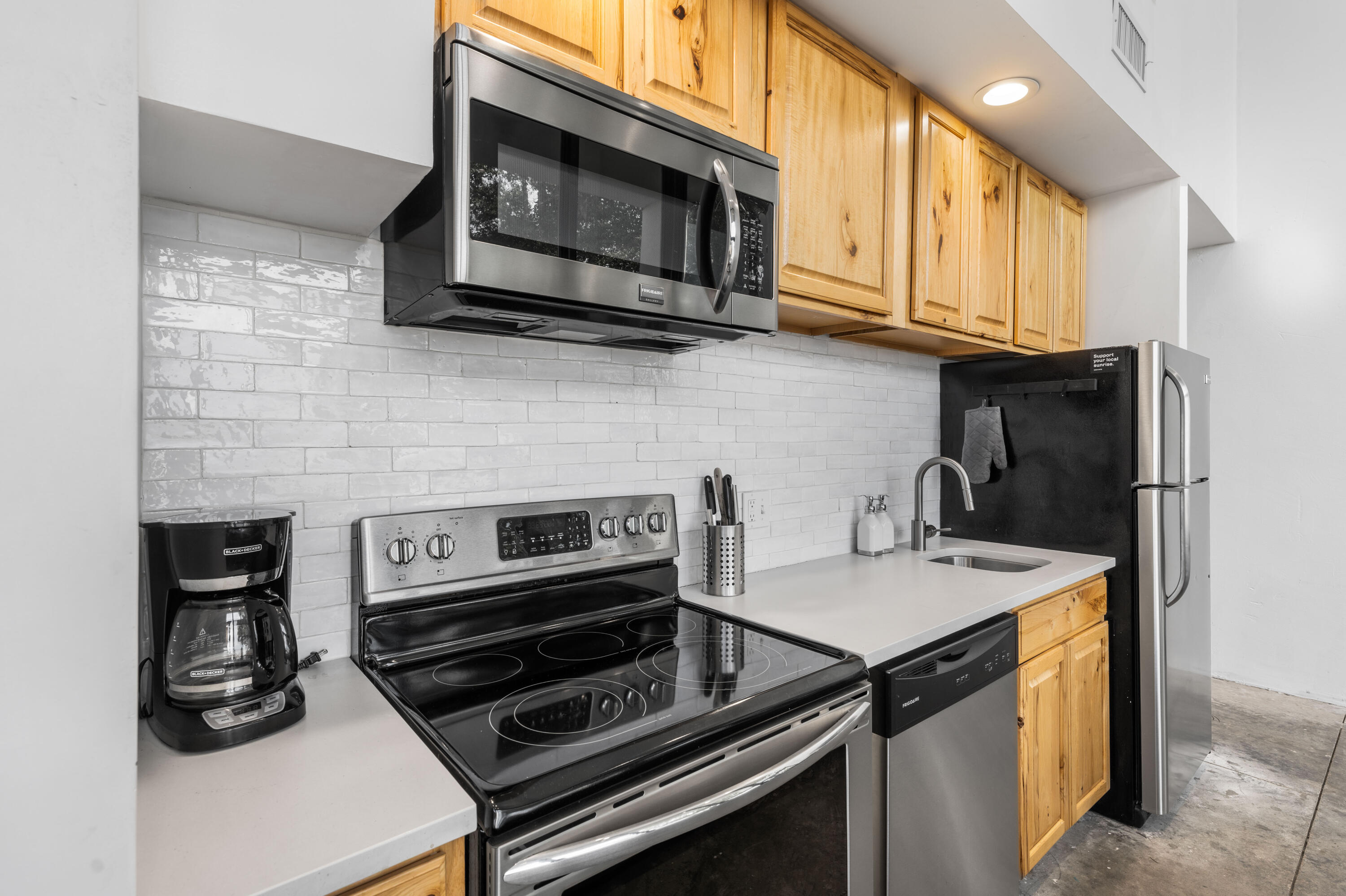 149 Native Tree Lane Santa Rosa Beach, FL 32459 - Photo 13 of 52 a kitchen with stainless steel appliances a stove a microwave a sink and cabinets