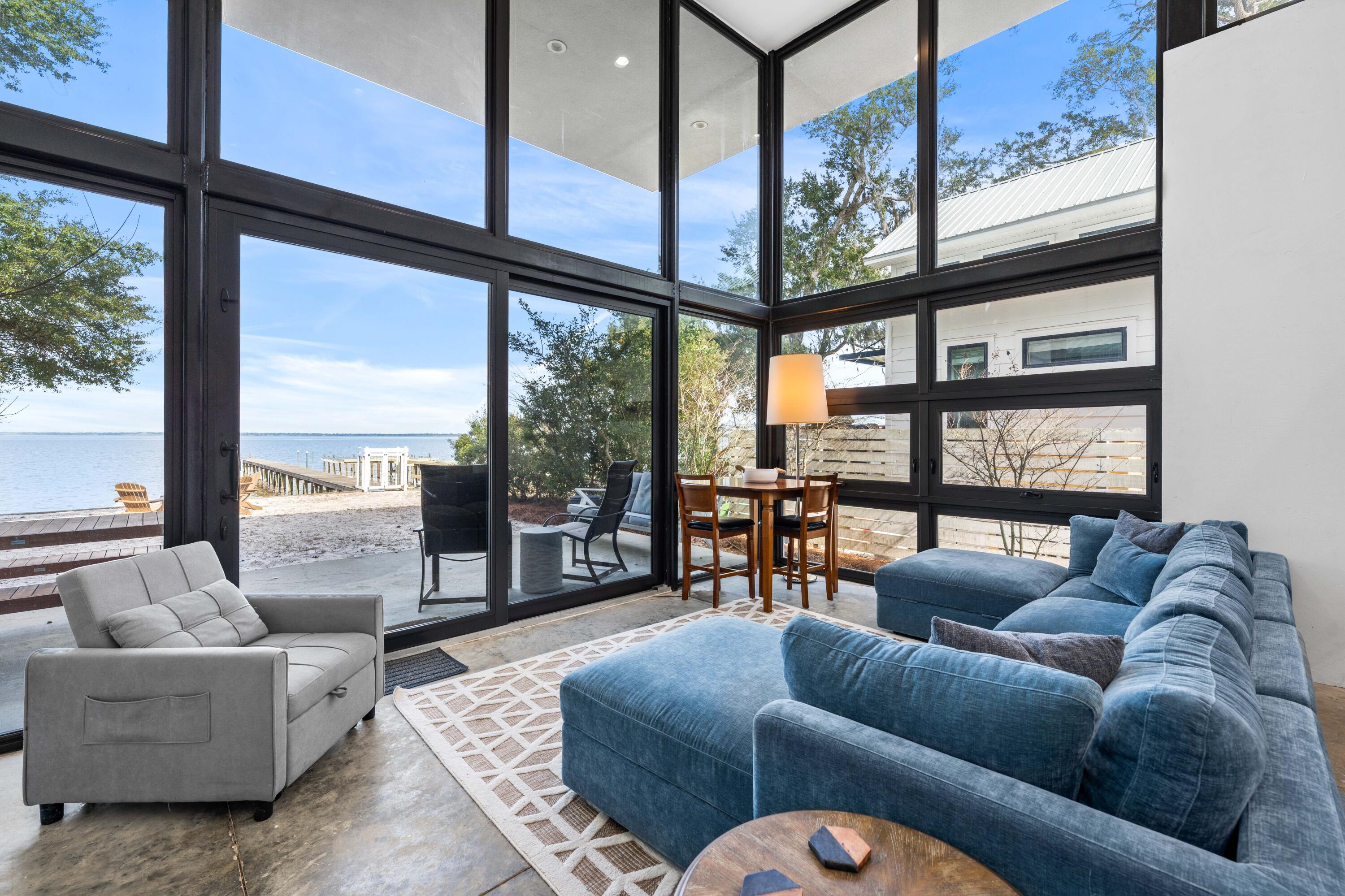 149 Native Tree Lane Santa Rosa Beach, FL 32459 - Photo 10 of 52 a living room with furniture and a large window