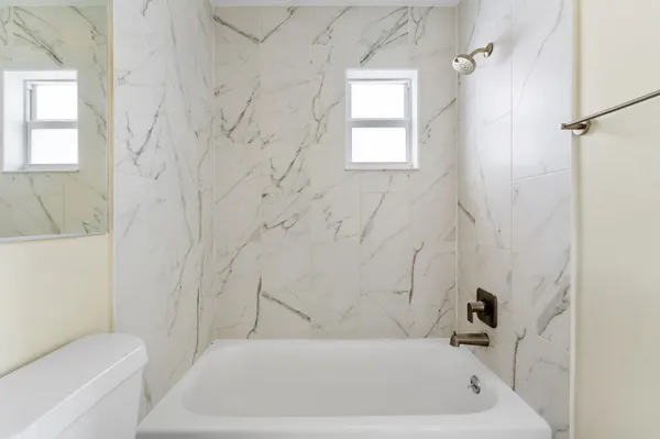 a bathroom with a bathtub and window