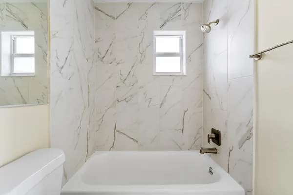 a bathroom with a bathtub and window