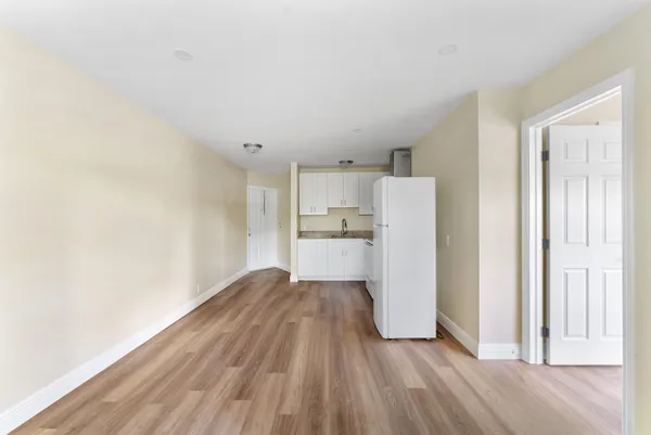 a view of a kitchen with wooden floor