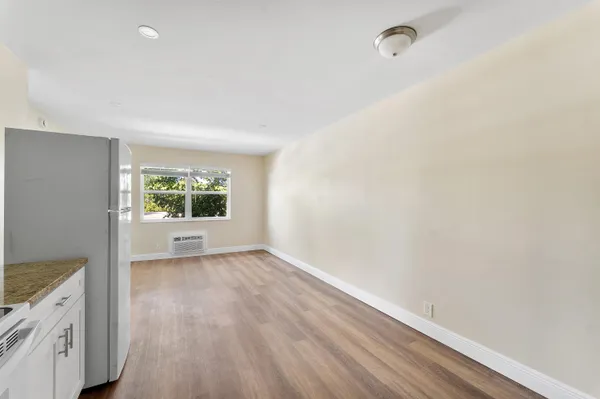 a view of a room with wooden floor and window