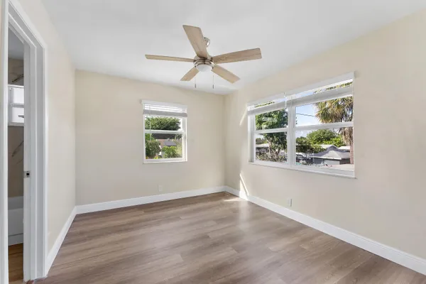 wooden floor in an empty room with a window