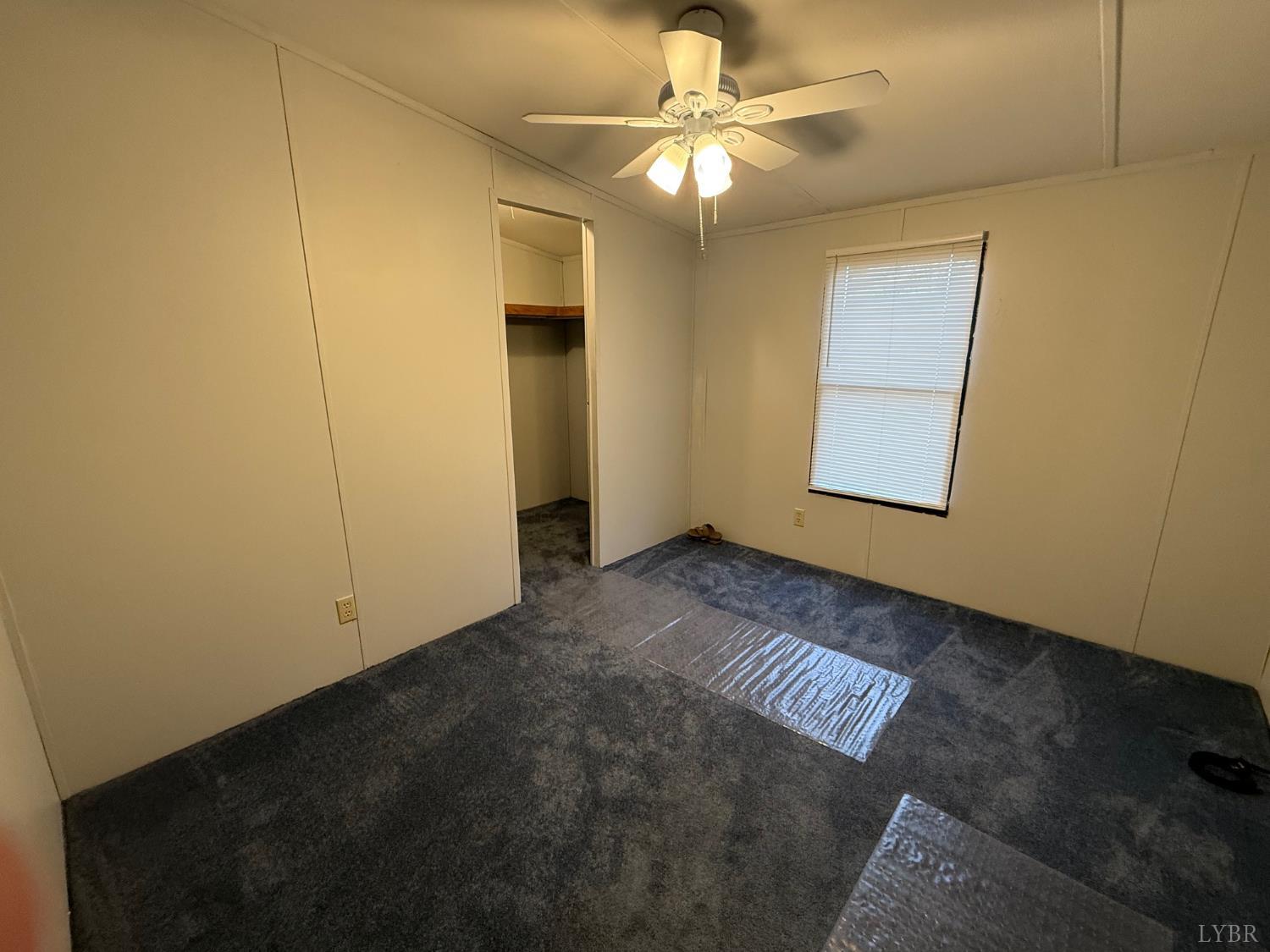 271 Candlemakers Lane Rustburg, VA 24588 - Photo 11 of 31 an empty room with windows and fan