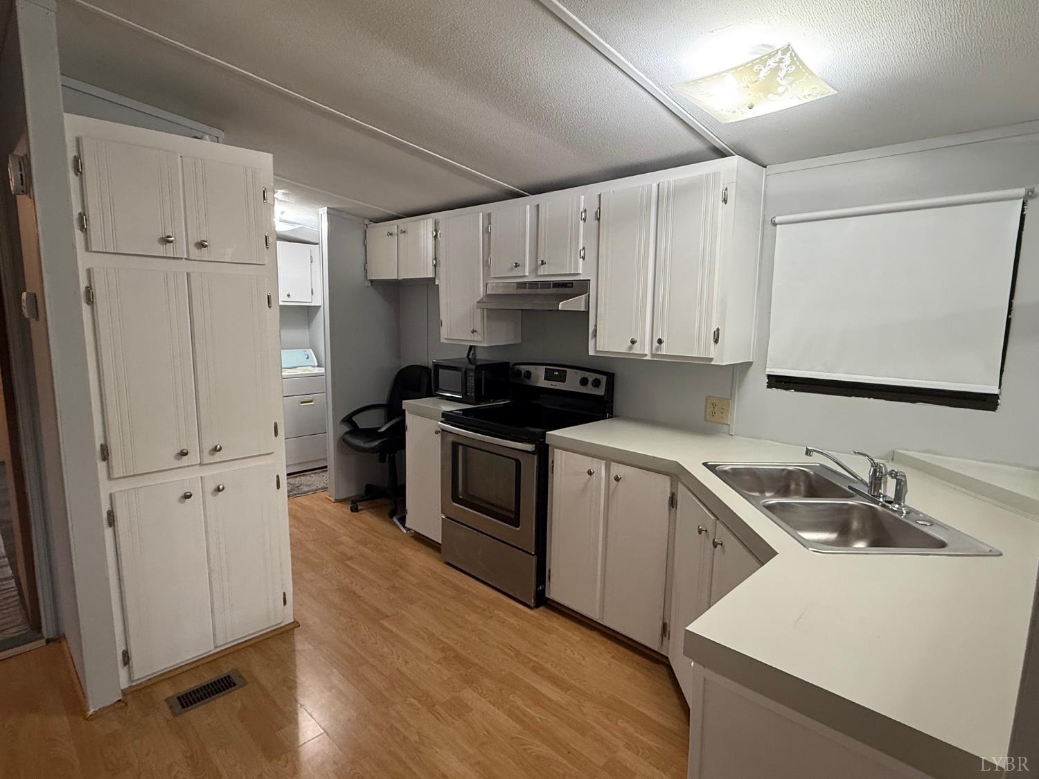 271 Candlemakers Lane Rustburg, VA 24588 - Photo 5 of 31 a kitchen with white cabinets sink and white appliances
