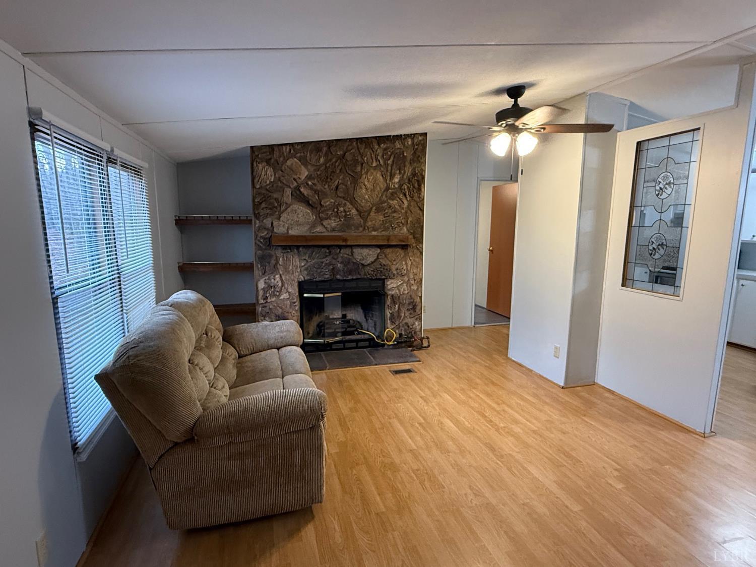 271 Candlemakers Lane Rustburg, VA 24588 - Photo 6 of 31 a living room with furniture and a fireplace