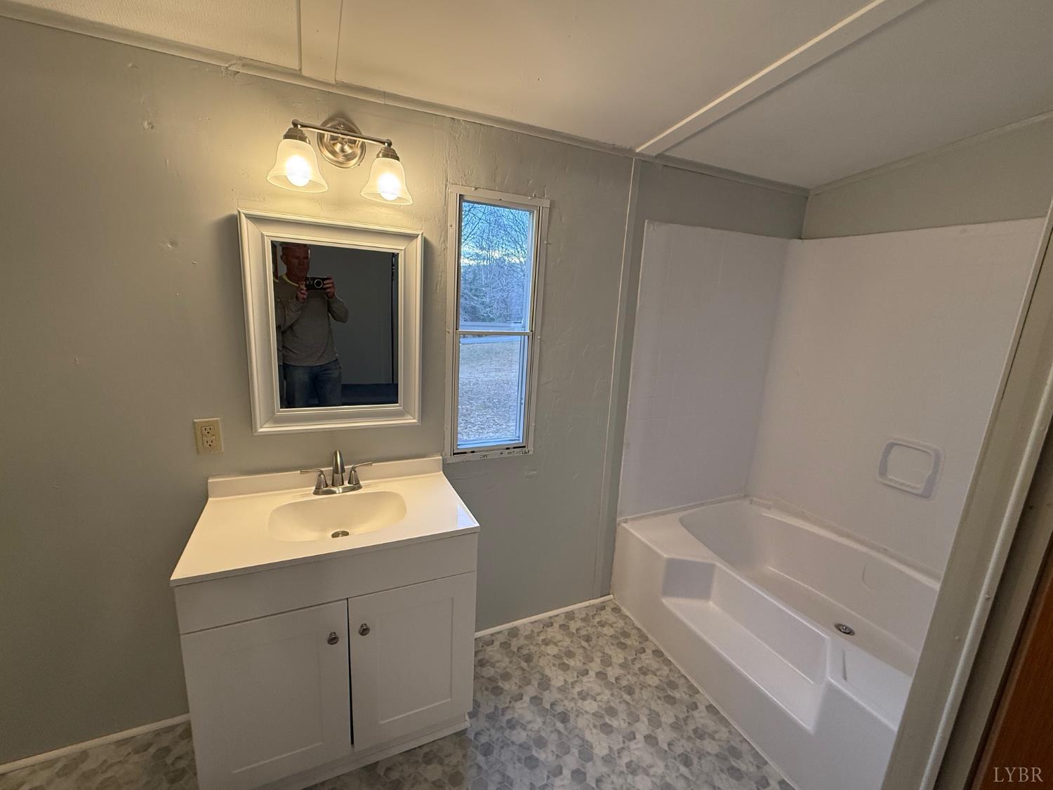 271 Candlemakers Lane Rustburg, VA 24588 - Photo 9 of 31 a bathroom with a sink and a mirror