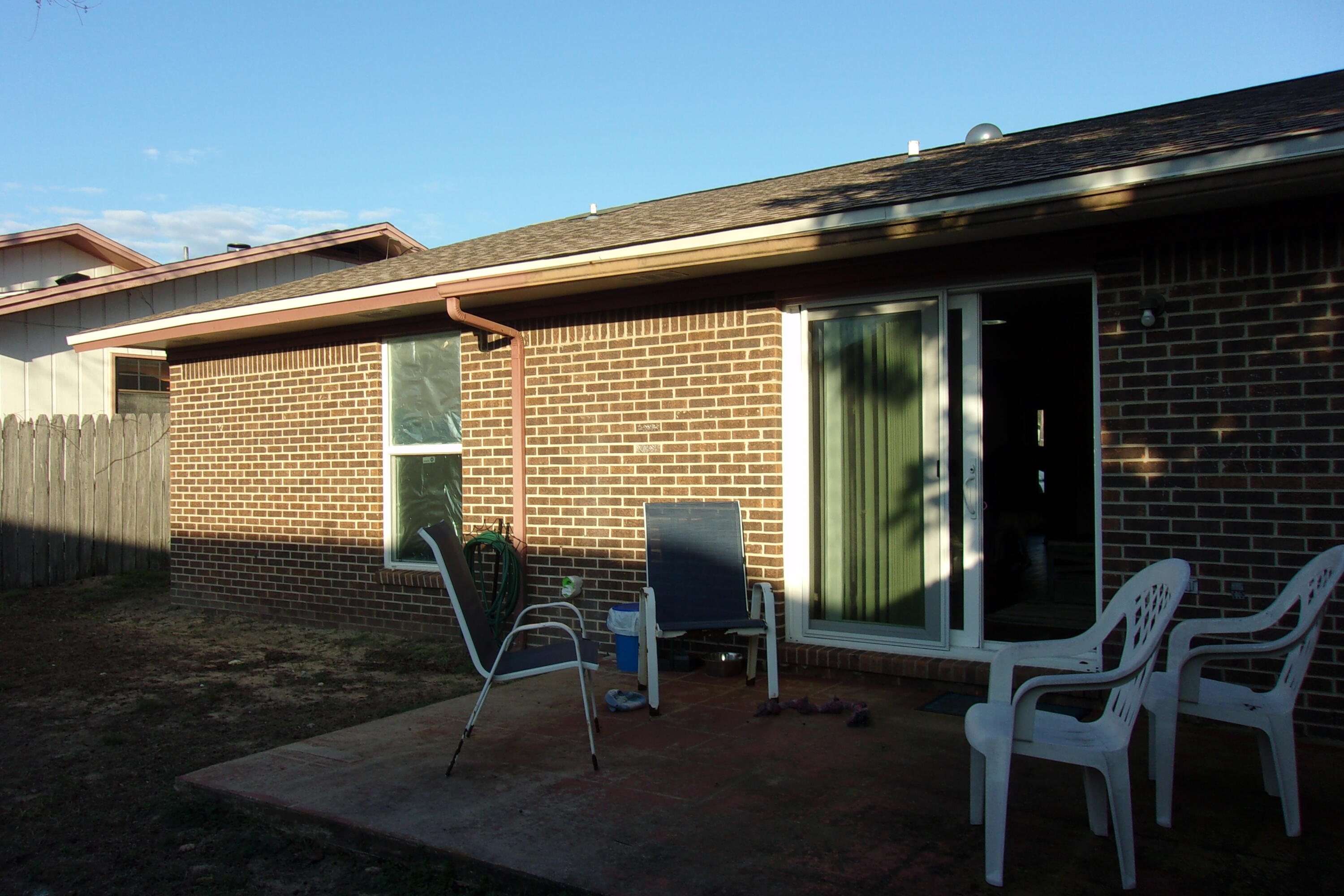 93 Cutter Lane Shalimar, FL 32579 - Photo 9 of 10 a porch with a chair and table in front of it