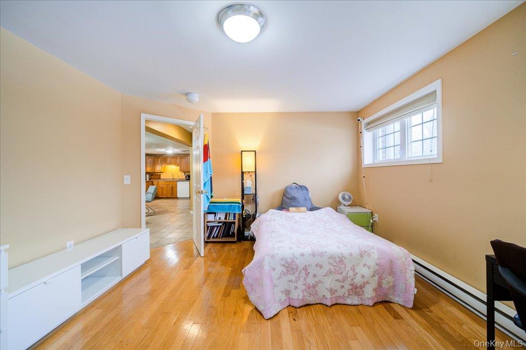 236 Budd Road Wurtsboro, NY 12790 - Photo 16 of 42 a bedroom with a bed and wooden floor