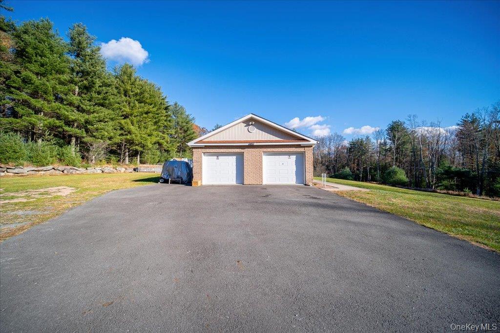 236 Budd Road Wurtsboro, NY 12790 - Photo 19 of 42 a front view of a house with a yard and garage