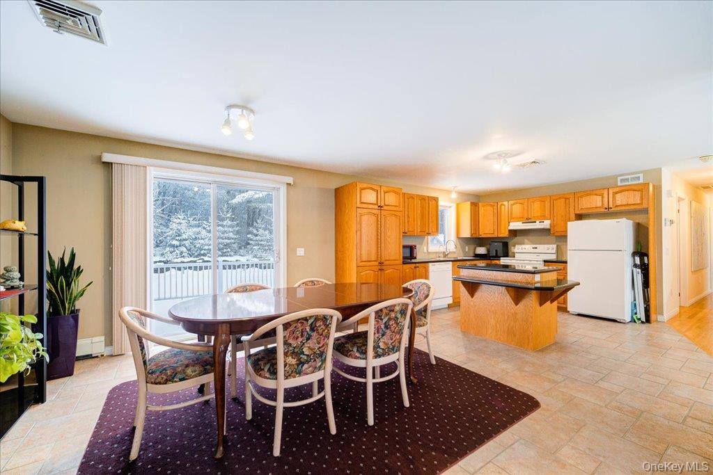 236 Budd Road Wurtsboro, NY 12790 - Photo 8 of 42 a dining room with furniture and a floor to ceiling window