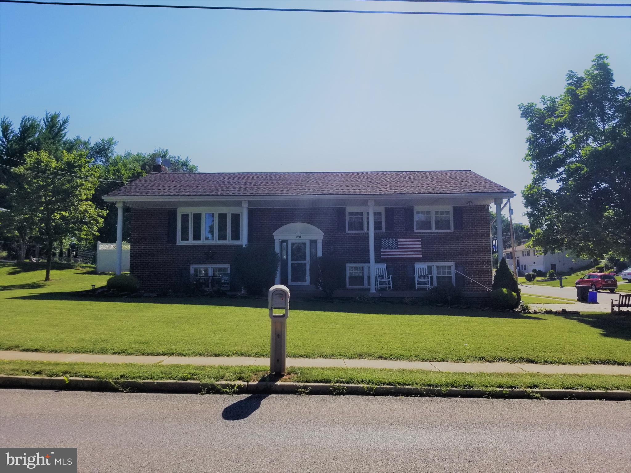 2025 Derry Road York, PA 17408 - Photo 1 of 45 a front view of a house with a garden and trees