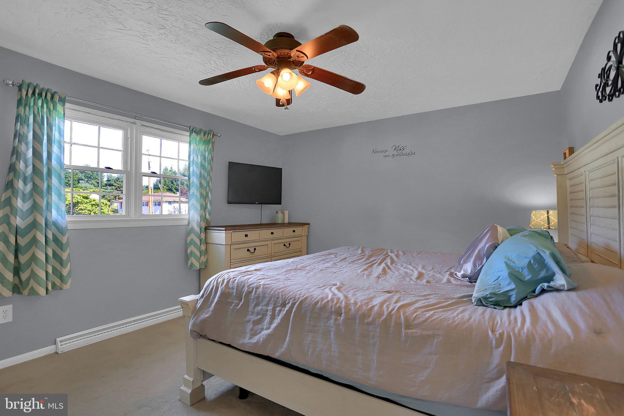 2025 Derry Road York, PA 17408 - Photo 22 of 45 a bedroom with a bed window and a flat screen tv