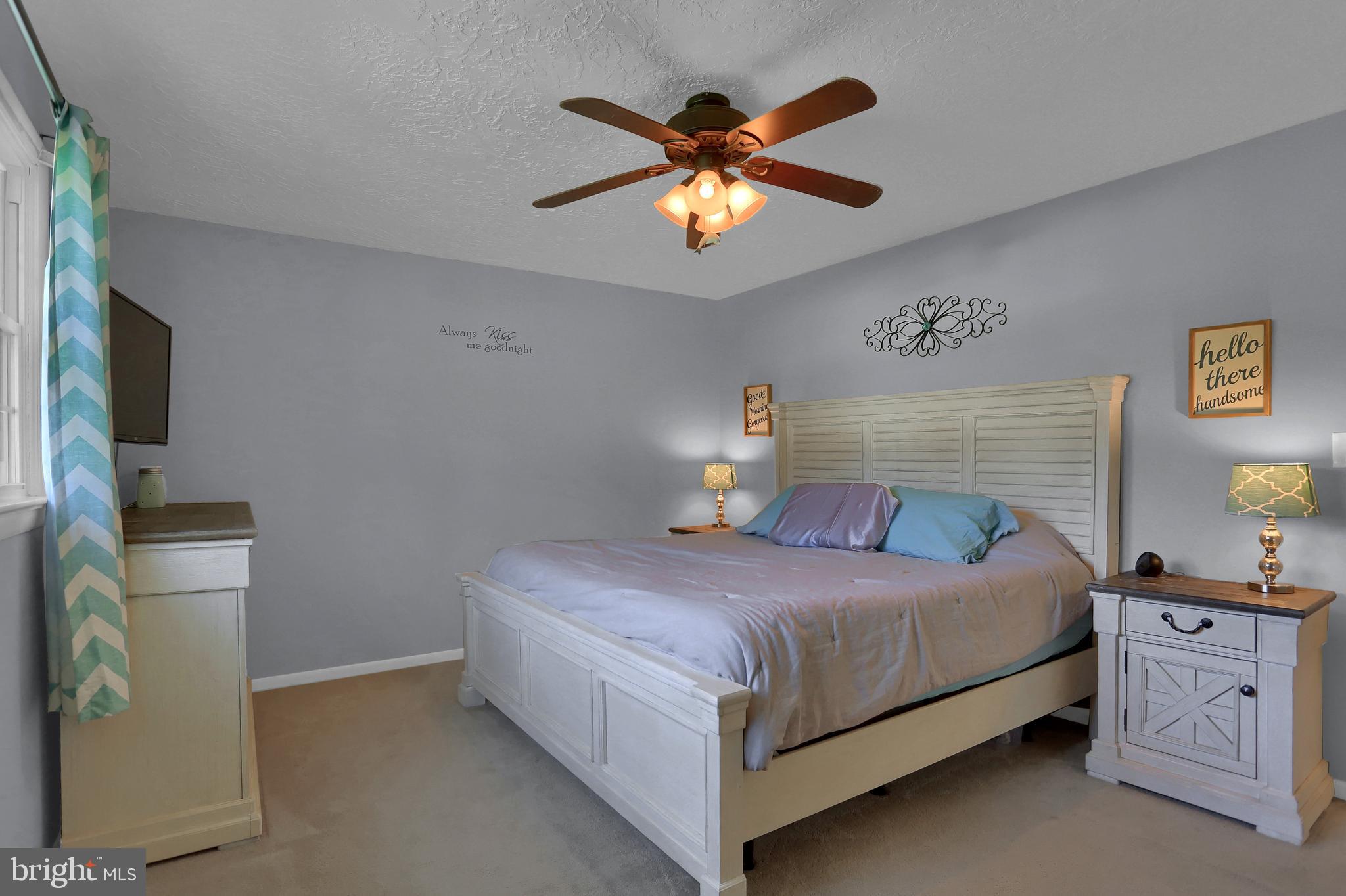 2025 Derry Road York, PA 17408 - Photo 23 of 45 a bedroom with a bed and a chandelier