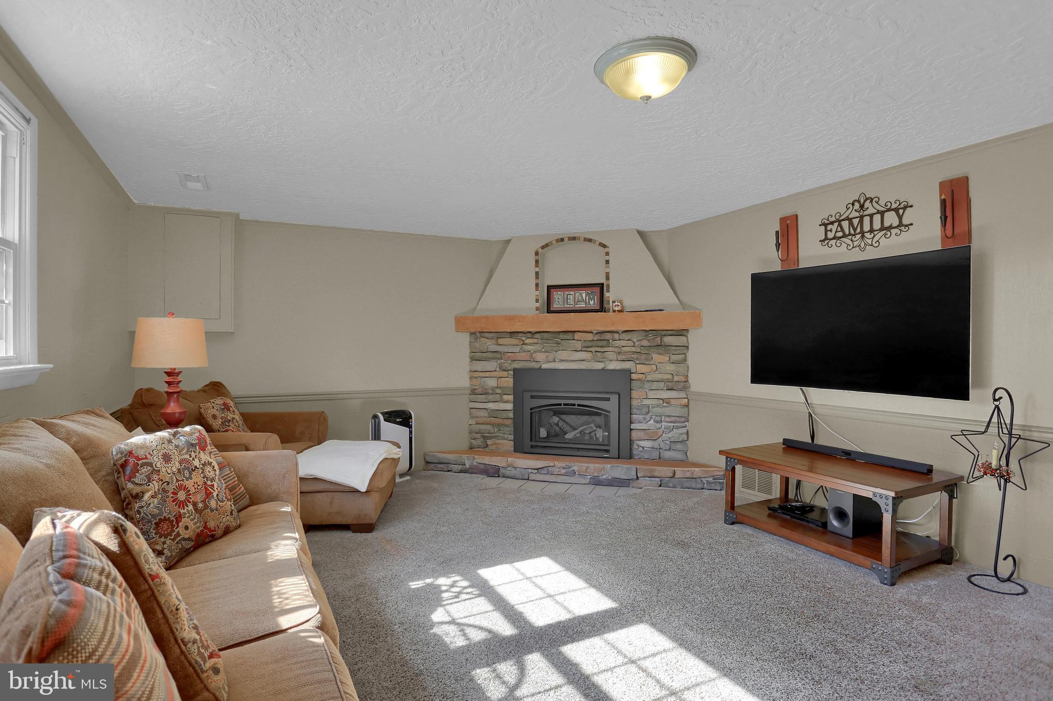 2025 Derry Road York, PA 17408 - Photo 27 of 45 a living room with furniture and a flat screen tv