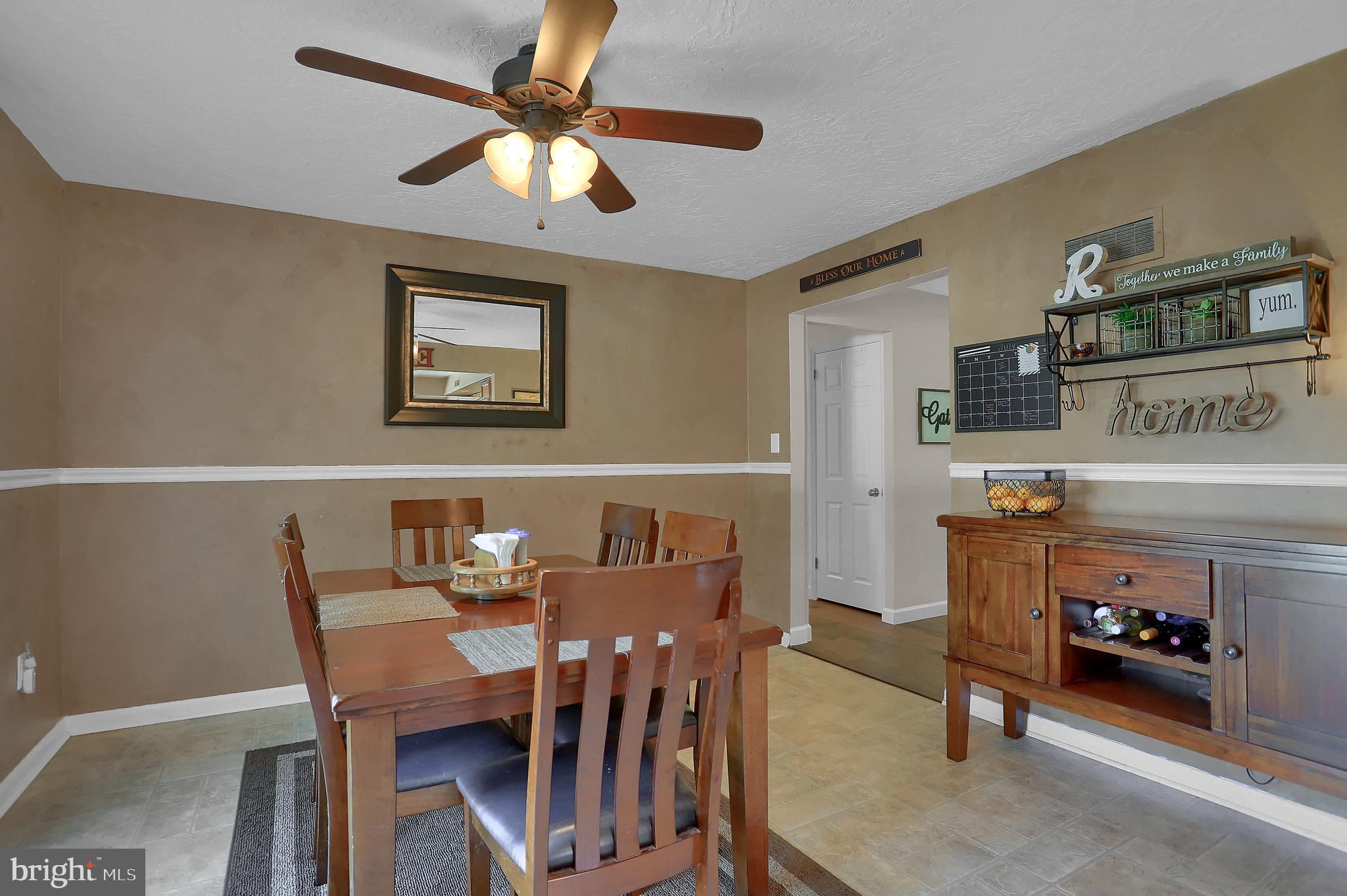 2025 Derry Road York, PA 17408 - Photo 10 of 45 a view of a dining room with furniture and a chandelier fan