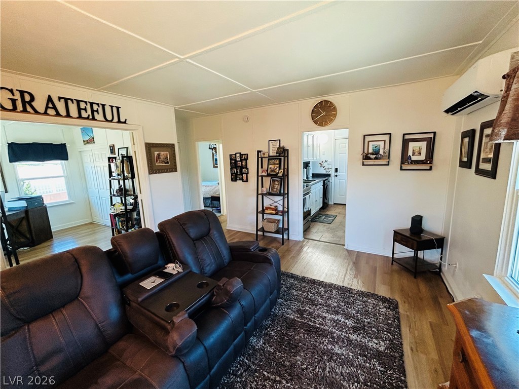 116 West Basic Road Henderson, NV 89015 - Photo 19 of 39 Hardwood flooring extends throughout this well-lit living area, offering clear sightlines into the adjacent kitchen.