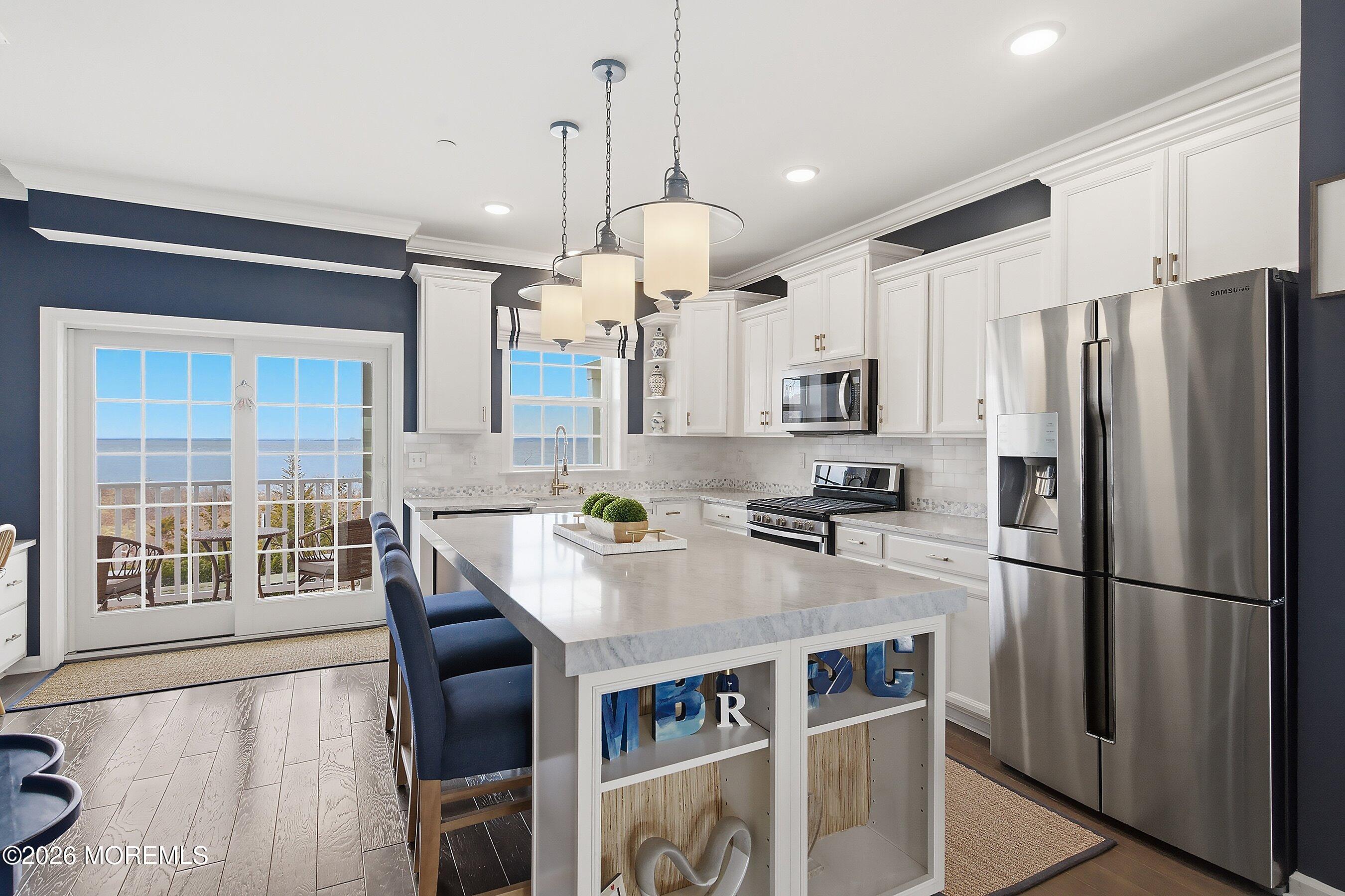 14 Lighthouse Point Road, Unit 604 Highlands, NJ 07732 - Photo 12 of 41 a kitchen with stainless steel appliances granite countertop a refrigerator a stove and a wooden floors
