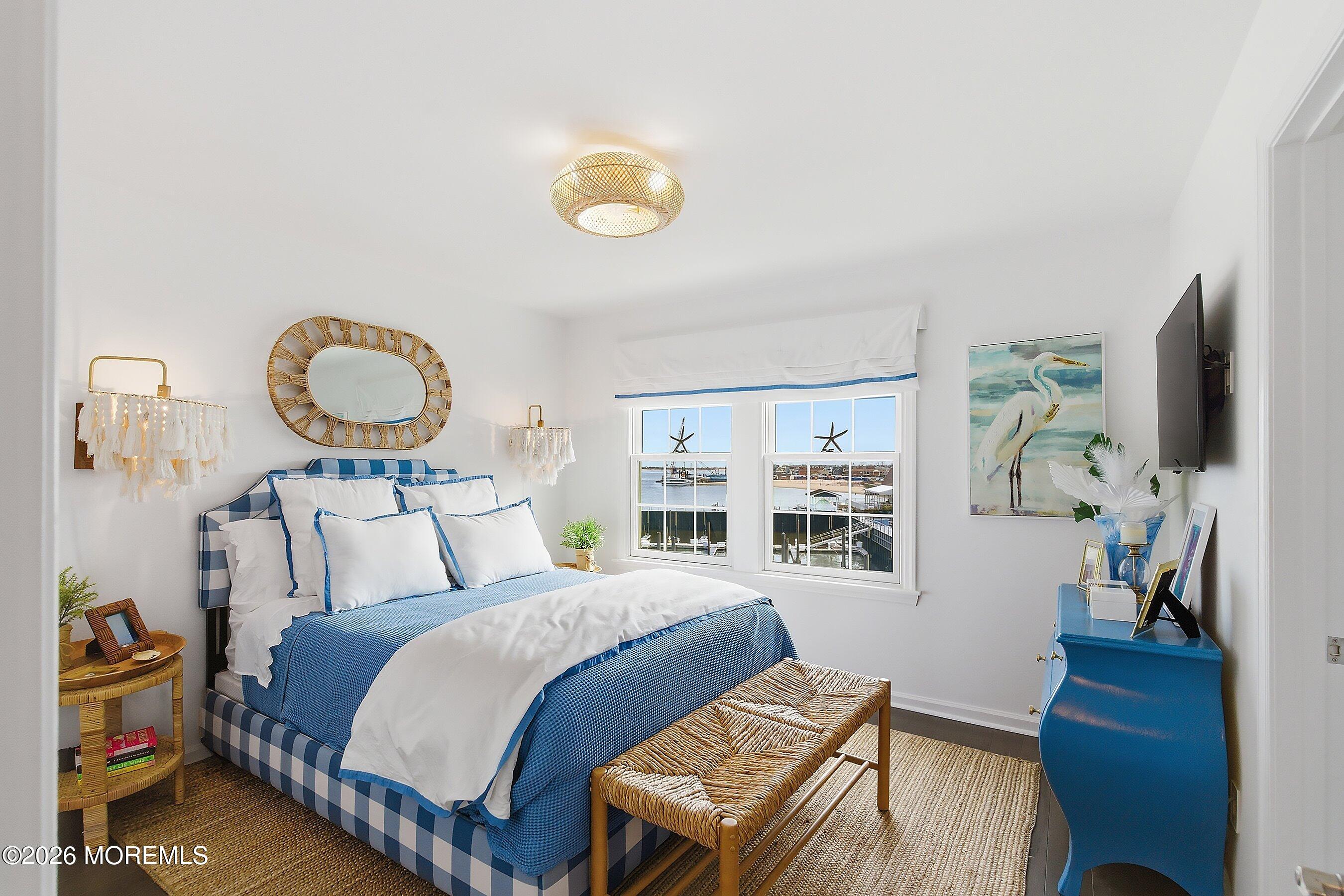 14 Lighthouse Point Road, Unit 604 Highlands, NJ 07732 - Photo 24 of 41 a bedroom with bed and a flat screen tv