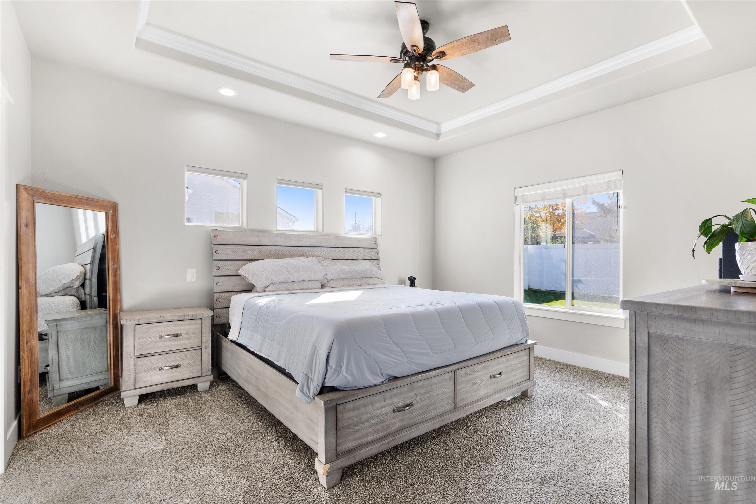 2958 Sunlight Road Twin Falls, ID 83301 - Photo 18 of 40 Recessed lighting, ceiling fan, tray ceiling, carpet flooring, and multiple windows