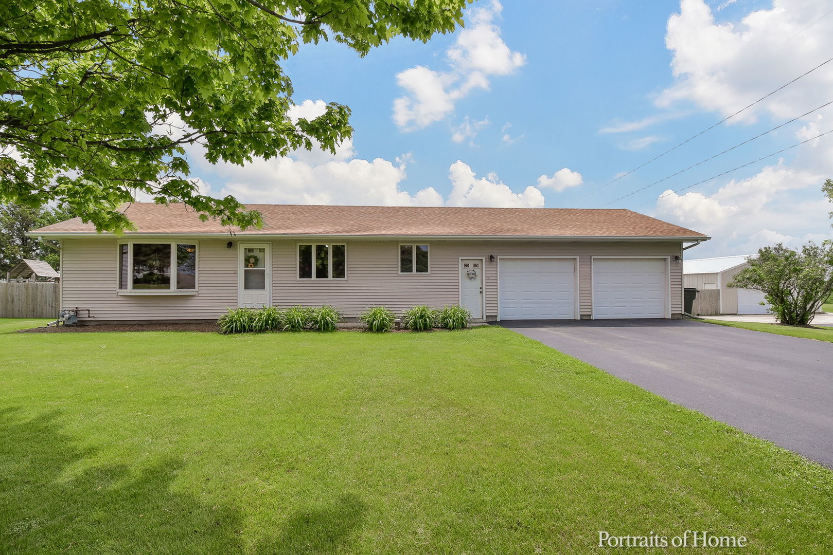 10522 Perry Road DeKalb, IL 60115 - Photo 1 of 27 a front view of a house with a garden