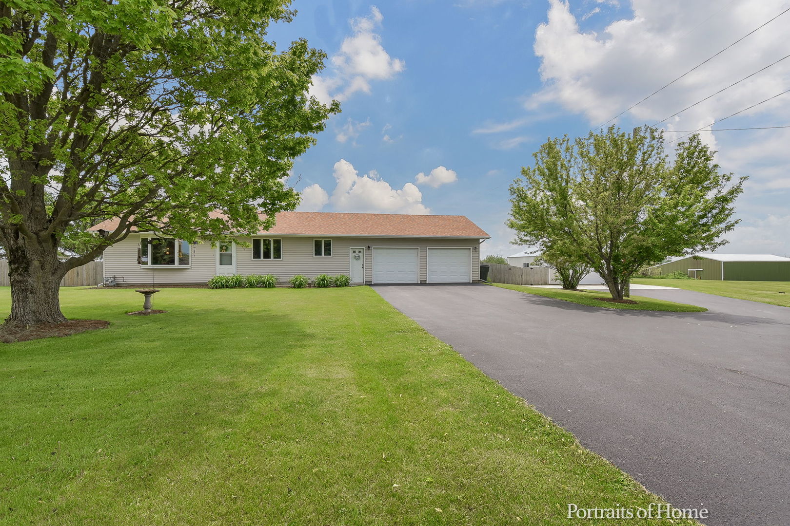 10522 Perry Road DeKalb, IL 60115 - Photo 27 of 27 a front view of a house with a yard and a garage
