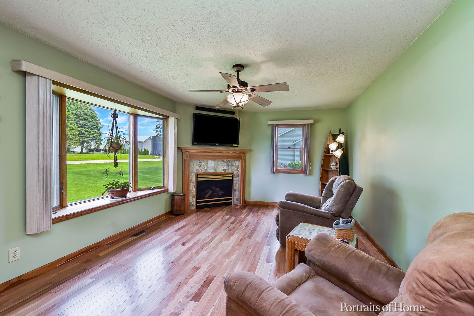 10522 Perry Road DeKalb, IL 60115 - Photo 4 of 27 a living room with furniture a fireplace and a floor to ceiling window