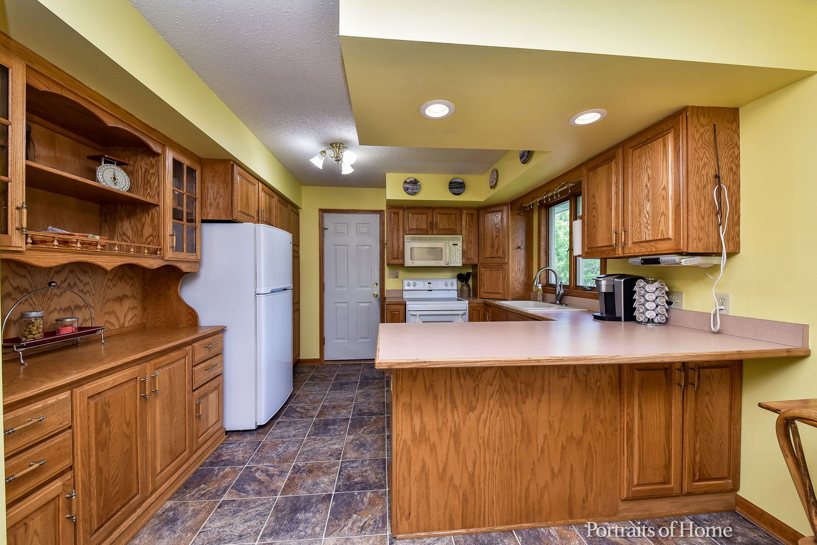 10522 Perry Road DeKalb, IL 60115 - Photo 7 of 27 a kitchen with stainless steel appliances granite countertop a refrigerator a stove and a sink