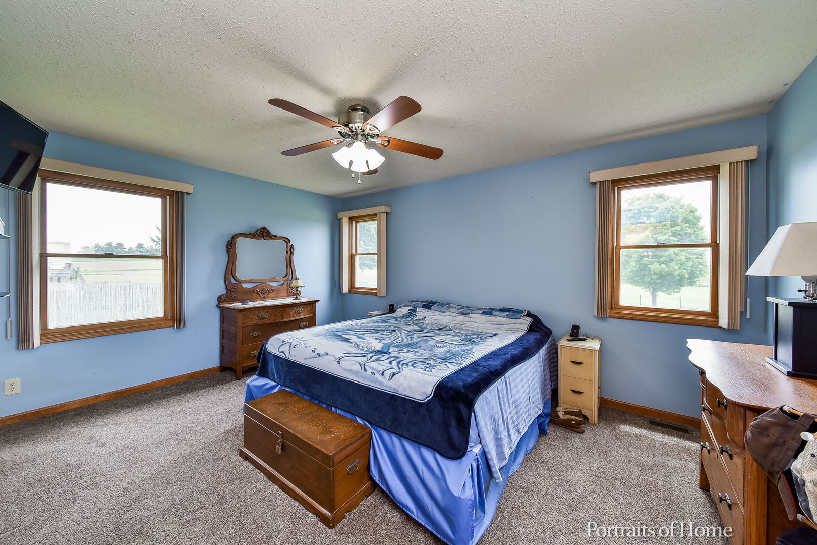 10522 Perry Road DeKalb, IL 60115 - Photo 9 of 27 a bedroom with a bed and a chandelier next to a window