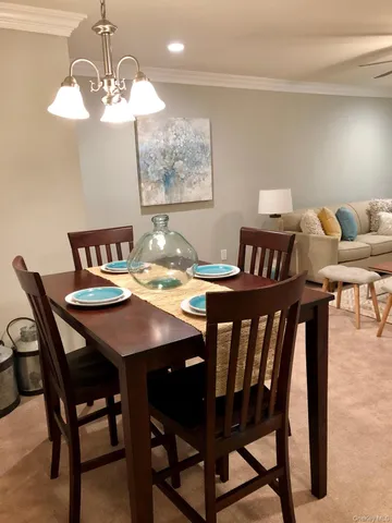 a view of a dining room and a table and chairs