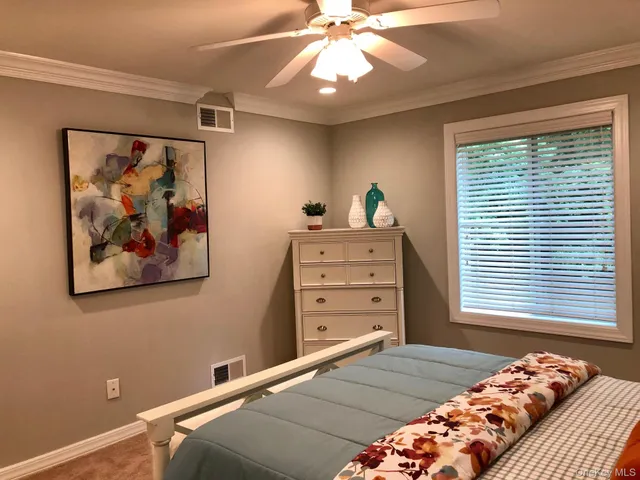 a bedroom with a bed and a window