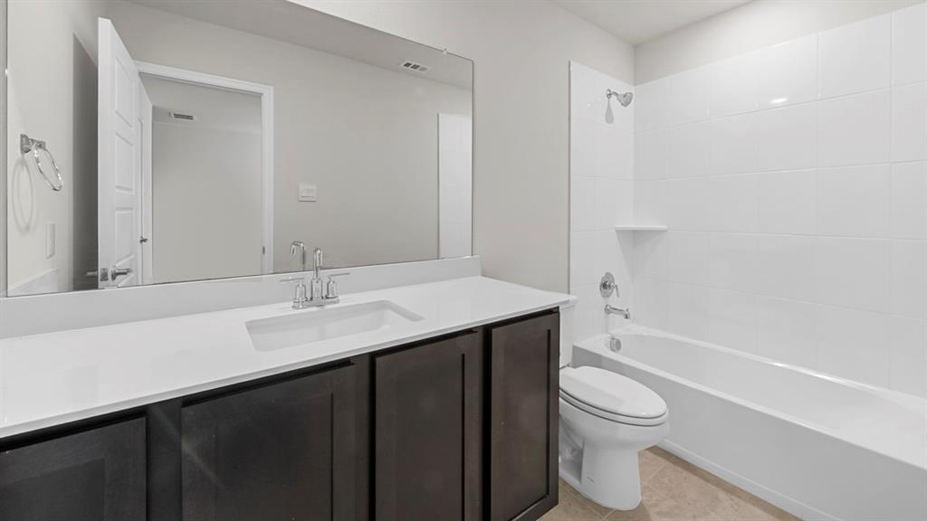 2328 Chloe Lane Anna, TX 75409 - Photo 6 of 37 a bathroom with a sink a toilet and shower