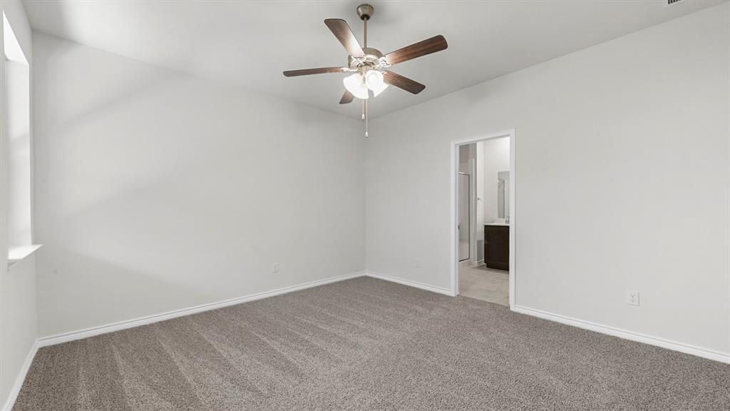 2328 Chloe Lane Anna, TX 75409 - Photo 9 of 37 an empty room with a ceiling fan and a window