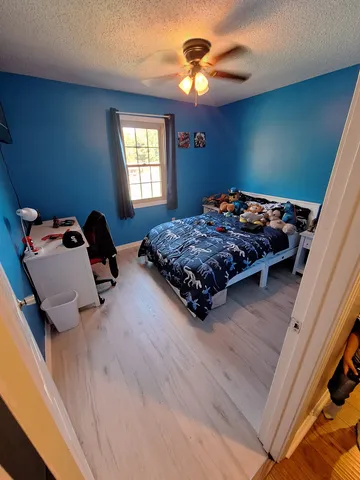 a bedroom with bed and a window