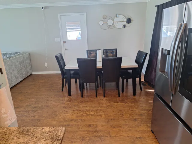 a dining room with furniture and window