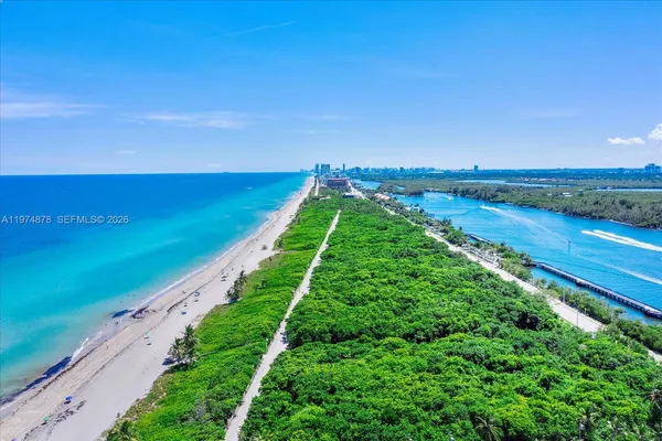 a kitchen with stainless steel appliances granite countertop a table chairs and a refrigerator