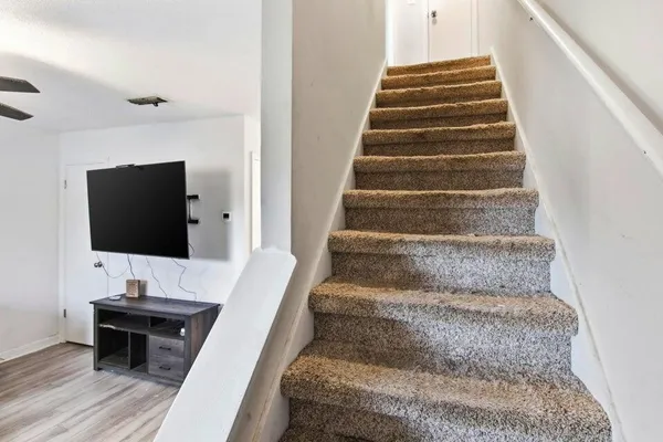 a view of entryway and hall with wooden floor
