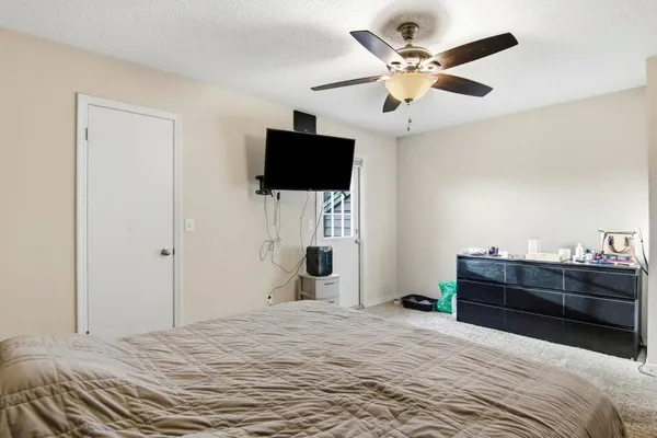 a bedroom with a bed and a flat screen tv