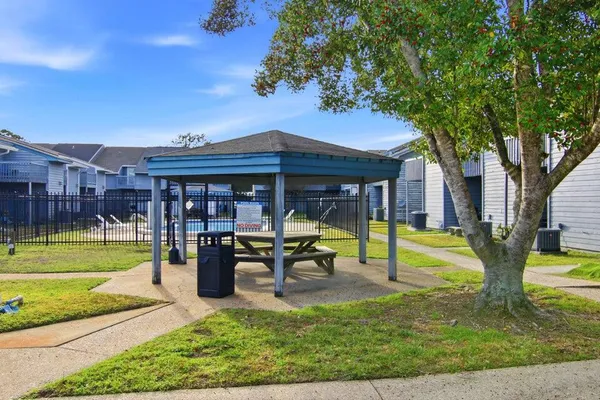 a swimming pool with outdoor seating and yard