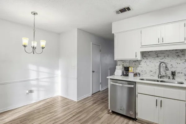 a view of cabinets and wooden floor