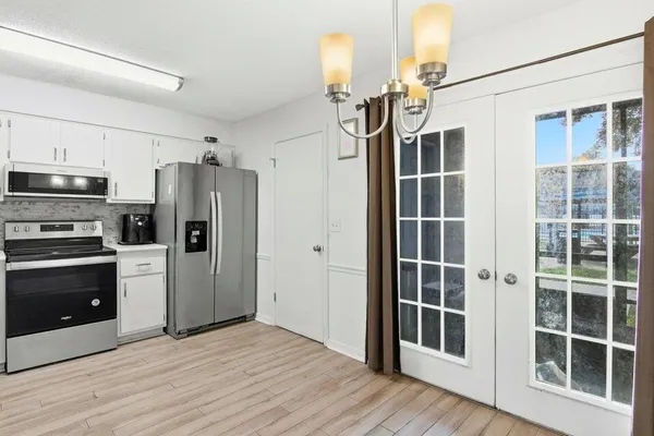 a kitchen with stainless steel appliances a refrigerator and a stove top oven