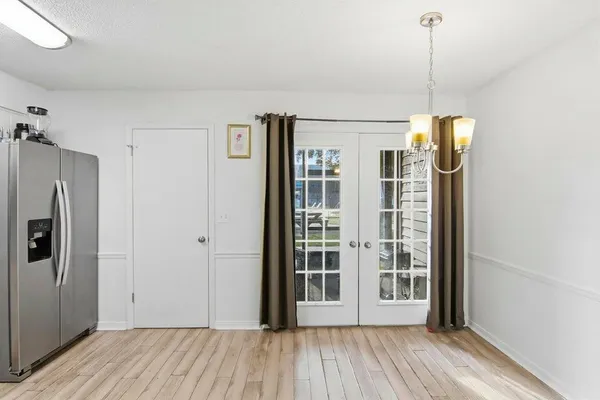 a view of a room with wooden floor and windows