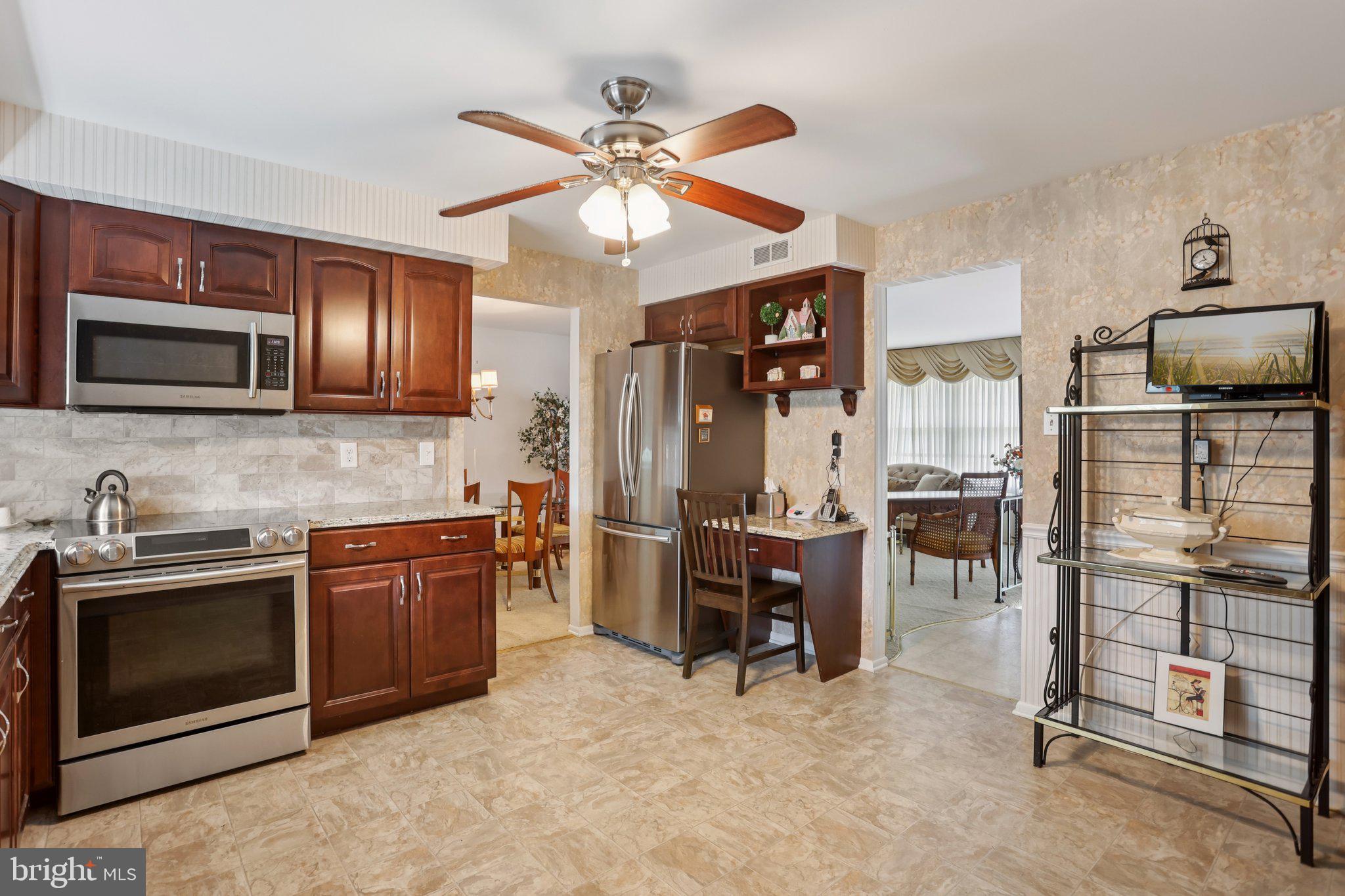 26 Regent Road Cherry Hill, NJ 08003 - Photo 13 of 36 a kitchen with stainless steel appliances granite countertop a stove microwave and sink