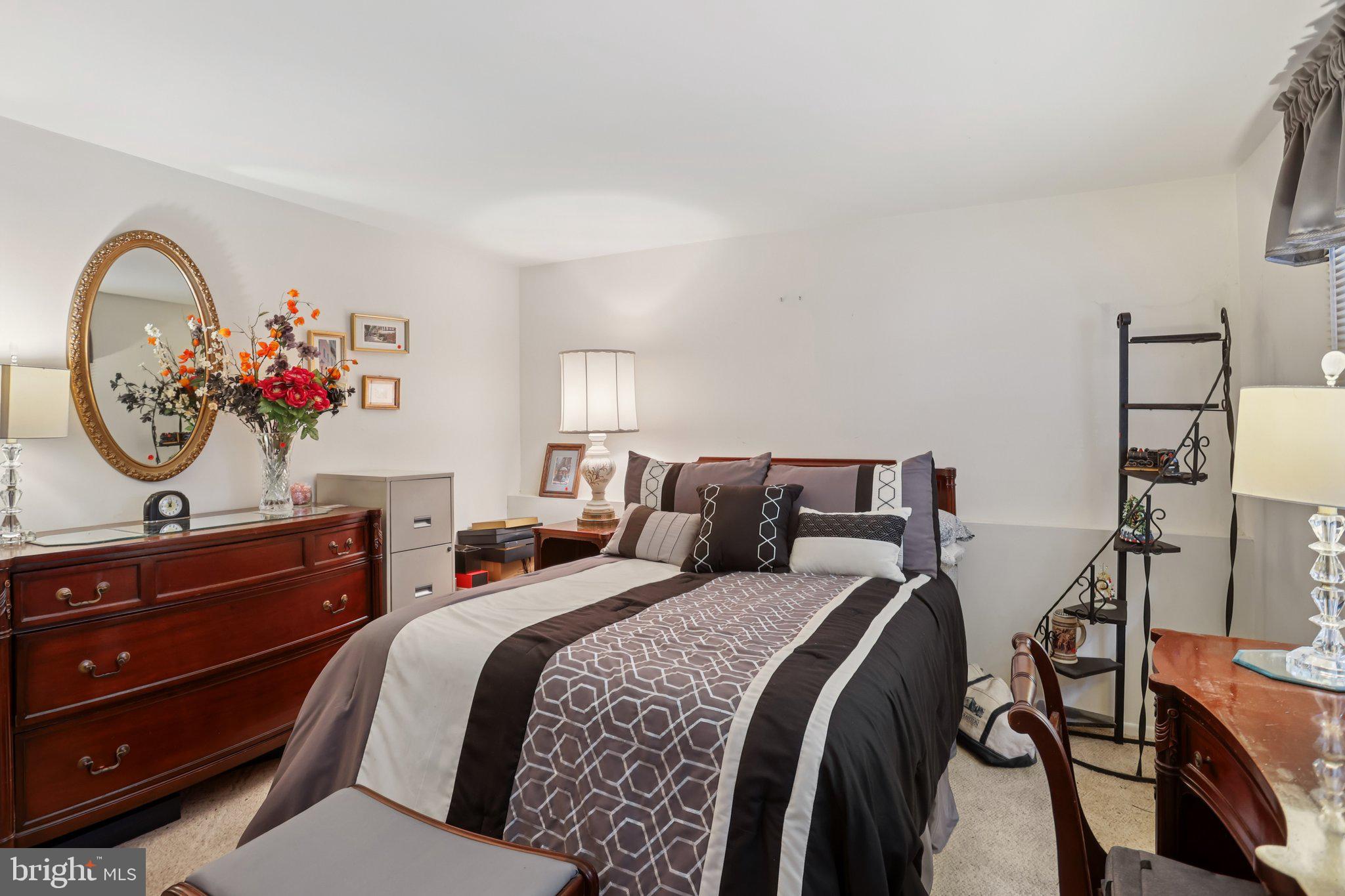 26 Regent Road Cherry Hill, NJ 08003 - Photo 17 of 36 a bedroom with a bed and a chandelier