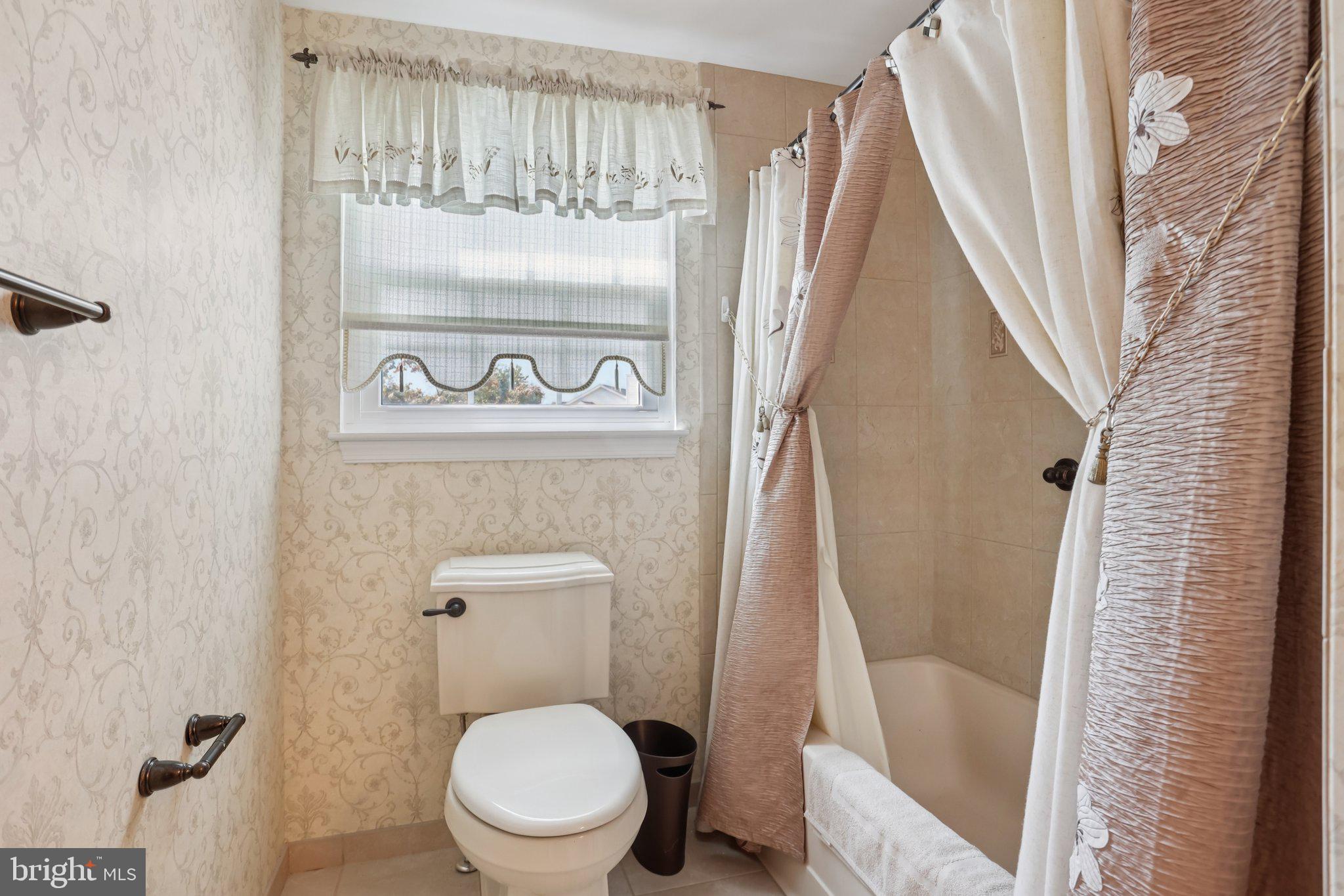 26 Regent Road Cherry Hill, NJ 08003 - Photo 23 of 36 a white toilet sitting next to a bathroom sink and a shower